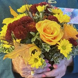 This is the bouquet she received. It looks NOTHING like the photo. Daisies?? I paid $62+ for this??