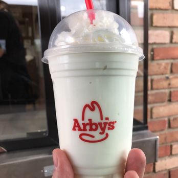 Arby's - a hand holding a cup of milkshake - Fast Food Near Me - Cuyahoga Falls, Ohio