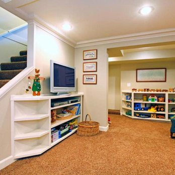 Tri-R Construction and Remodeling - a living room with a tv, bookshelf, and stairs - General Contractors Near Me Tri-R Construction and Remodeling - a living room with a tv, bookshelf, and stairs - General Contractors Near Me