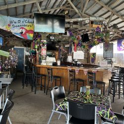 Purple Parrot Tiki Bar & Grill - Inside bar. No one here door open lol small sign says 12