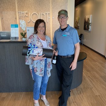 The Joint Chiropractic - Dr. Mike with the winner of our wine and wellness package! - Chiropractors Near Me - Athens, Georgia