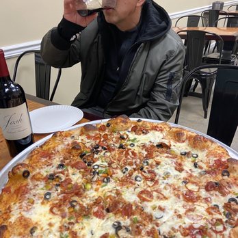 Shore Slice Pizza & Grill - a man drinking a glass of wine - Pizza Near Me - Seaside Heights, New Jersey