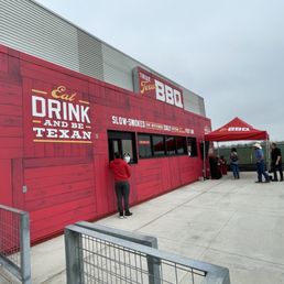 a man standing outside of a red building a man standing outside of a red building