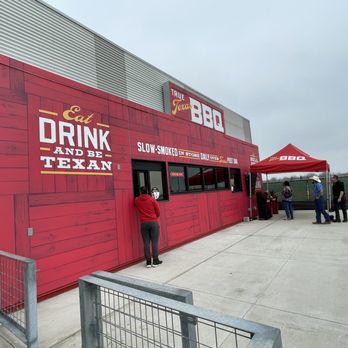 True Texas BBQ - a man standing outside of a red building - Barbeque Near Me - Manvel, Texas True Texas BBQ - a man standing outside of a red building - Barbeque Near Me - Manvel, Texas