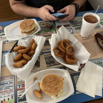 Crossroads Grill - a man sitting at a table with plates of food - American Near Me - Taylorsville, North Carolina
