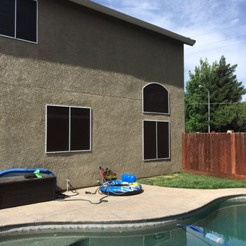Steve's Mobile Sunscreens Inc - a pool in a backyard - General Contractors Near Me