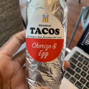 Mockingbird - a hand holding a taco wrapped in foil - Breakfast & Brunch Near Me - Brooklyn, New York