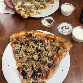 Gio's Pizza - Rear slice is smelly Tahitian and front slice is Da big uncle Joey with olive and fresh garlic! - Pizza Near Me - Santa Rosa, California Gio's Pizza - Rear slice is smelly Tahitian and front slice is Da big uncle Joey with olive and fresh garlic! - Pizza Near Me - Santa Rosa, California