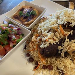 The lamb shank with my choice of side (hummus), comes with small salad. The lamb shank with my choice of side (hummus), comes with small salad.