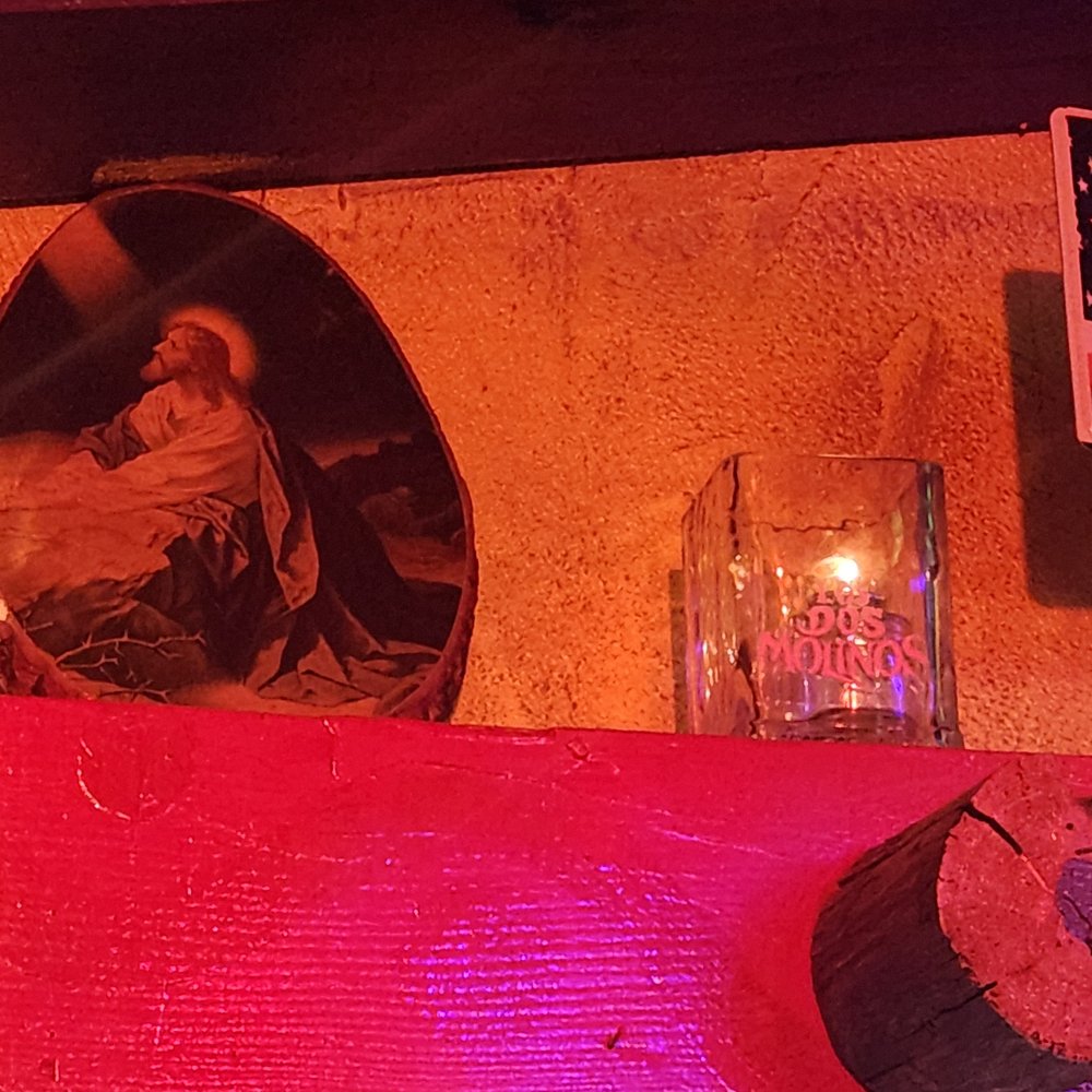 Los Dos Molinos - candles lit by the picture of Jesus - New Mexican Cuisine Near Me - Phoenix, Arizona Los Dos Molinos - candles lit by the picture of Jesus - New Mexican Cuisine Near Me - Phoenix, Arizona