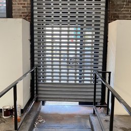Exterior outside entrance of Delta Iron Works - Entry Door Motorized Roll Up Gate - Philadelphia, Pennsylvania Exterior outside entrance of Delta Iron Works - Entry Door Motorized Roll Up Gate - Philadelphia, Pennsylvania