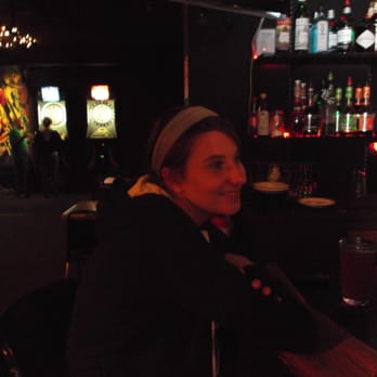 Corner Pocket - a woman sitting at a bar - Dive Bars Near Me - Seattle, Washington