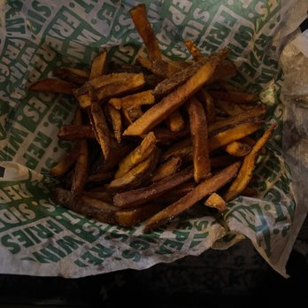Wingstop - a basket of french fries in a wrapper - Chicken Wings Near Me - Mansfield, Texas