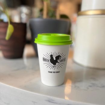 Rooster Coffee House - a cup of coffee on a table - Coffee & Tea Near Me - Toronto, Ontario Rooster Coffee House - a cup of coffee on a table - Coffee & Tea Near Me - Toronto, Ontario