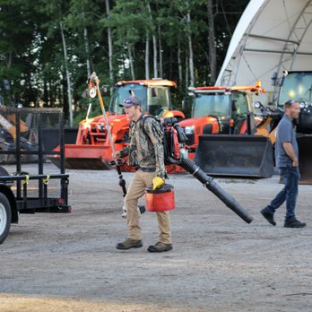 Dykstra Landscape Management - a man carrying a large pipe - Landscaping Near Me - Grand Haven, Michigan Dykstra Landscape Management - a man carrying a large pipe - Landscaping Near Me - Grand Haven, Michigan