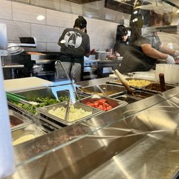 people preparing food in a restaurant kitchen people preparing food in a restaurant kitchen