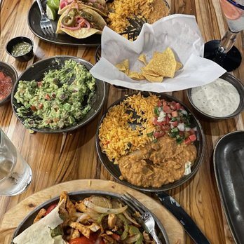 Coyol - Our table was full of good things! Chicken fajitas with rice and beans, guacamole and a carnitas street taco plate - Mexican Near Me - Coeur d'Alene, Idaho