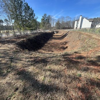 Landscape Escape - Overgrown detention pond cleared. - Lawn Services Near Me