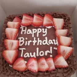 Chocolate cake topped with fresh strawberries.