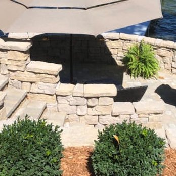 Lowrie's Landscape - a stone patio with a table and chairs - Landscaping Near Me - Village Of Clarkston, Michigan