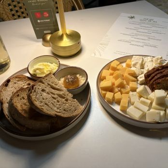 Canopy Wine Lounge - House made sourdough with egg yolk and butter, and a cheese plate they so kindly put together for us! - Wine Bars Near Me - Palm Springs, California Canopy Wine Lounge - House made sourdough with egg yolk and butter, and a cheese plate they so kindly put together for us! - Wine Bars Near Me - Palm Springs, California