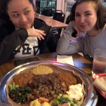 Cafe Selam - "When bae looks at you like how she looks at her Ethiopian food"  This is the meat and veggie combo. So delicious!! - Ethiopian Near Me - Seattle, Washington
