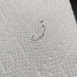 Piece of metal from stainless steel scrubber Piece of metal from stainless steel scrubber