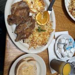 2 over hard eggs with 2 pork chops, hashbrowns and a side of sourdough toast (2 slices) 2 over hard eggs with 2 pork chops, hashbrowns and a side of sourdough toast (2 slices)