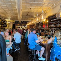 Inside. Bar and dining room. Busy on a Thursday evening. Book reservations on OpenTable.