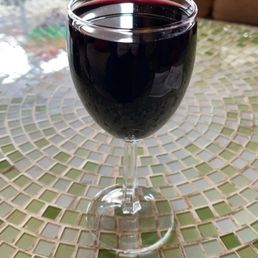 a glass of wine on a mosaic table