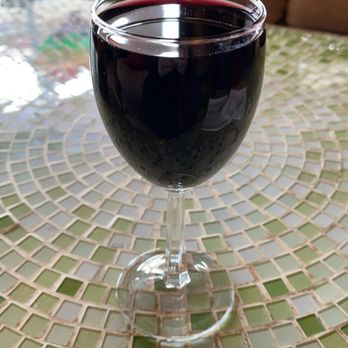 Wine Vault - a glass of wine on a mosaic table - Beer, Wine & Spirits Near Me - Charlotte, North Carolina