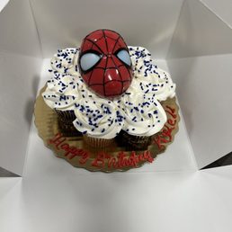 a spider - man cupcake in a box