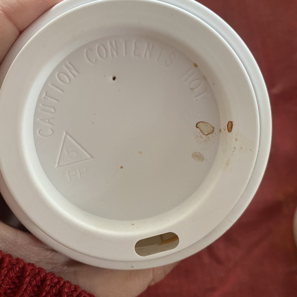 a person holding a cup of coffee a person holding a cup of coffee