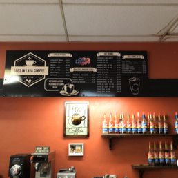 a coffee shop with a menu on the wall a coffee shop with a menu on the wall