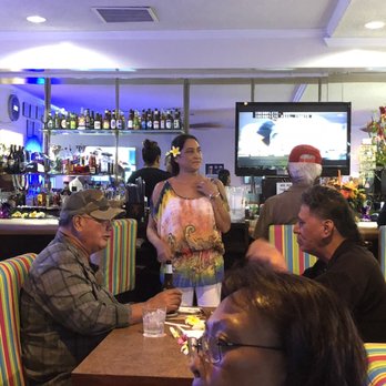 Aloha Lounge - a group of people sitting at a table - Lounges Near Me - Honolulu, Hawaii
