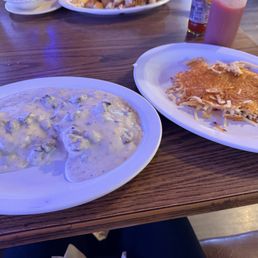 Biscuit with gravy and hash browns.