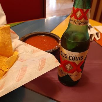 Fiesta Charra - a beer and chips on a table - Mexican Near Me - East Lansing, Michigan Fiesta Charra - a beer and chips on a table - Mexican Near Me - East Lansing, Michigan