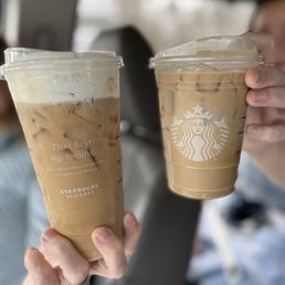 two cups of iced coffee in a car