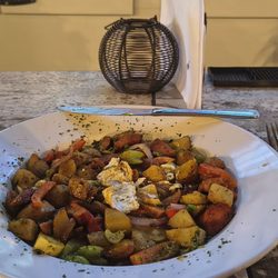 The Raven Social - The Cajun Brunch Bowl: Andouille sausage, roasted potatoes, Cajun Trinity with mixed summer veggies in a lemon caper remoulade sauce.