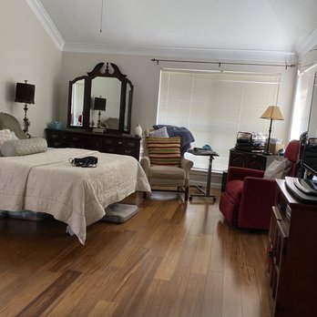 Gmz Renovations - a bedroom with a bed and a chair - General Contractors Near Me Gmz Renovations - a bedroom with a bed and a chair - General Contractors Near Me