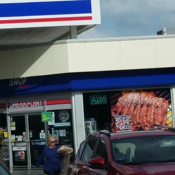 Double E BBQ - two cars parked in front of a gas station - Barbeque Near Me - Mccomb, Mississippi