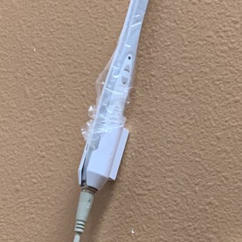Friendly Dental Center - Camera with plastic covering still on used to take photos of my teeth put back against the porous drywall - Cosmetic Dentists Near Me - Murrieta, California