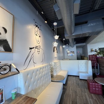 Tea Rak Tea - a panda sitting on a bench in a coffee shop - Bubble Tea Near Me - Dallas, Texas Tea Rak Tea - a panda sitting on a bench in a coffee shop - Bubble Tea Near Me - Dallas, Texas