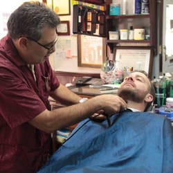 Scottsdale Barber Shop - Rafi cleaning up the neck line on a beard.