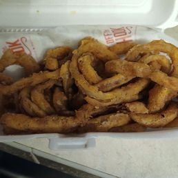 Onion rings that were fried in burnt oil.