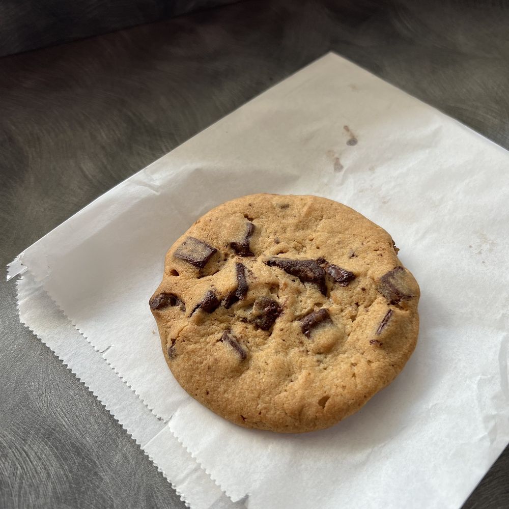 a chocolate chip cookie on a napkin a chocolate chip cookie on a napkin