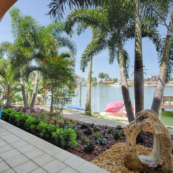 Outdoor Oasis Pro - a view of the water and palm trees - Landscaping Near Me Outdoor Oasis Pro - a view of the water and palm trees - Landscaping Near Me