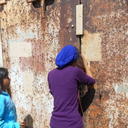 Looking into an old gun emplacement for leftover soldiers ... or old ammo we can take to school.