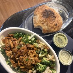 Salad: greens, grains, pita chips, slow roasted chicken, their "special green sauce" with cauliflower/broccoli. On the side: pita bread. Salad: greens, grains, pita chips, slow roasted chicken, their "special green sauce" with cauliflower/broccoli. On the side: pita bread.
