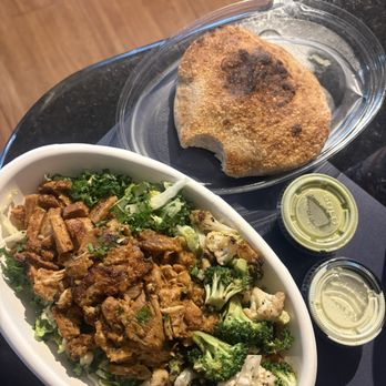 Brassica - Salad: greens, grains, pita chips, slow roasted chicken, their "special green sauce" with cauliflower/broccoli. On the side: pita bread. - Mediterranean Near Me - Houston, Texas